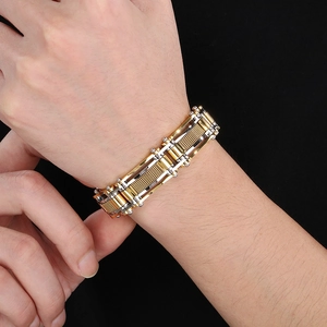 Close-up of industrial gold and silver mesh men's bracelet with mechanical link structure
