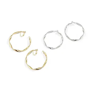 Detailed view of twisted gold and silver hoop earrings with adjustable screw clips