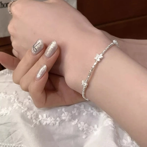 Elegant S925 sterling silver beaded bracelet with butterfly charms on female wrist