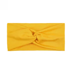 Close-up of a bright yellow knotted sports headband in high-stretch knit fabric texture