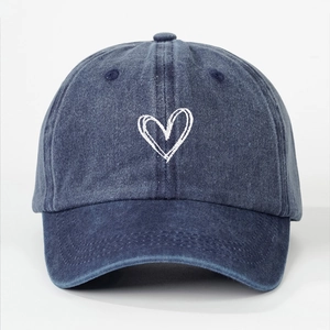 Vintage washed cotton baseball cap in denim blue with a white embroidered heart design