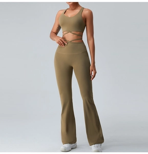 Detailed view of olive green sports bra with cross-strap back and high waist flared leggings