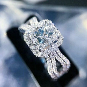 Macro detail of luxury split-shank engagement ring with halo-set square zircon