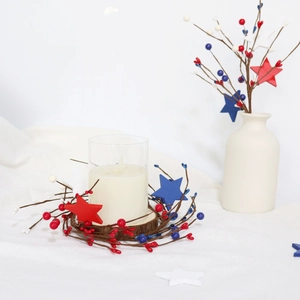 Detail of Fourth of July candle ring with red white blue berries and stars on glass