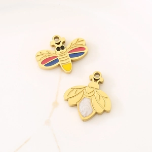 Detail of bee-shaped pendants in gold and enamel for creative DIY jewelry making