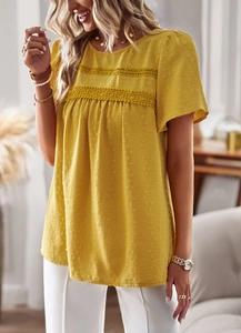 Close-up of yellow round neck top featuring textured fabric and delicate lace trim detail