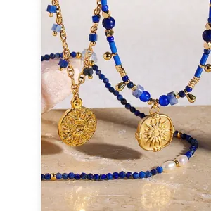 Lapis beads and gold plated brass necklace set with sun totem pendants and pearls
