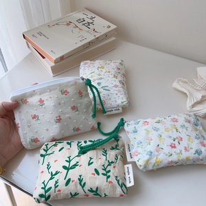 Close-up of four floral cotton pouches with rustic patterns and simple wish labels