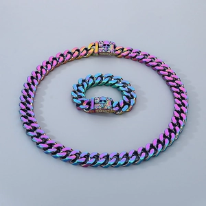 Macro view of iridescent skull Cuban chain necklace and bracelet set in stainless steel