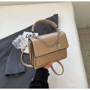 Detail of khaki leather handbag with silver chain strap and fashion logo print