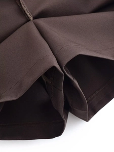 Detailed macro view of dark brown fabric stitching and high-quality sewing workmanship