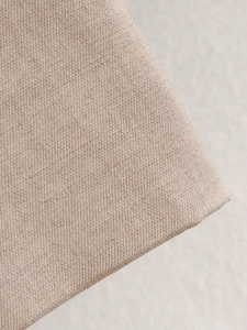 Macro shot showing the breathable khaki woven fabric texture of the jacket and pants set