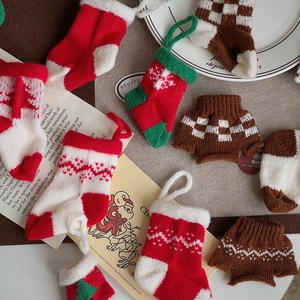Miniature knitted Christmas stockings and sweaters for festive tree ornaments and DIY craft
