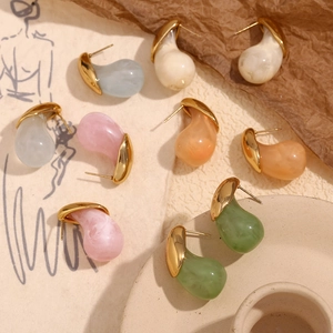 Close-up of teardrop resin earrings in candy colors with 18K gold plated metal borders
