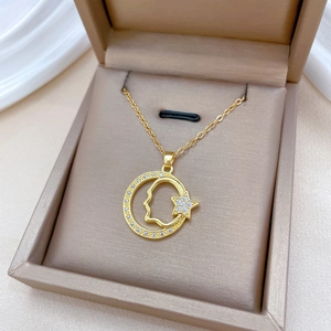 Titanium gold necklace with star and face outline pendant in a beige jewelry gift box