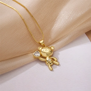 Macro shot of gold bear pendant holding a heart zircon with I Love U engraving