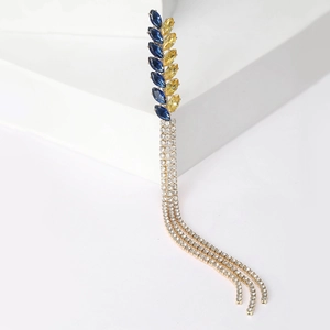 Golden wheat-shaped brooch with blue and yellow rhinestones and sparkling tassels