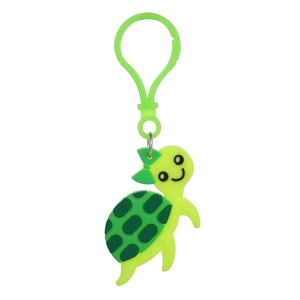 Close-up of green cartoon turtle keychain made of PVC with matching plastic hook and bow