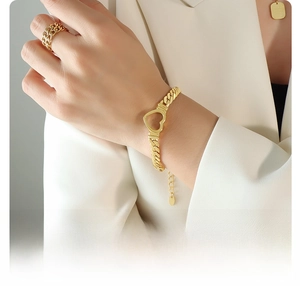 Detail of 18K gold plated surgical titanium steel bracelet with hollow heart design