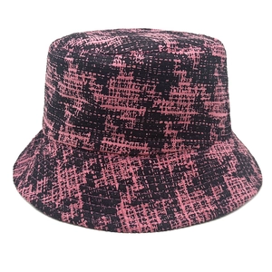 Close-up of the woven pink and black houndstooth fabric texture on this bucket hat