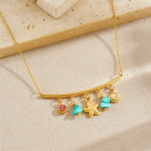 Golden stainless steel necklace with ocean charms like starfish and turquoise on beige base
