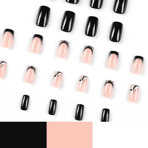 French press-on nails in black and white with gold glitter on a clean white background