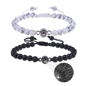 Detail of couple bracelets with 100 languages I Love You projection and adjustable cord
