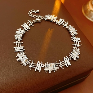 Detail view of silver zircon bracelet with square stones on a leather texture display
