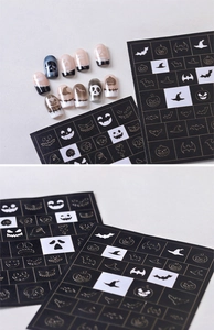 Macro shot of Halloween nail stencils showing pumpkin, skull and ghost airbrush patterns