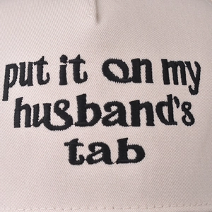 Beige cotton baseball cap with black Put It On My Husband's Tab embroidery on front