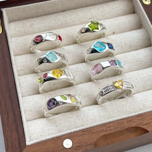 Detailed macro view of S925 sterling silver rings with colorful gemstone settings