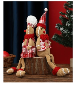 Close-up of sitting gingerbread plush dolls with corduroy texture for Christmas decor