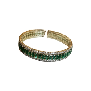Elegant gold open bangle with square emerald gemstone and white diamond accents