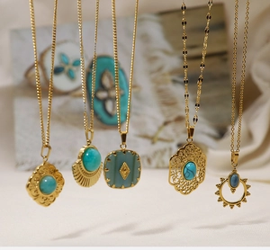 Detailed close-up of bohemian style gold necklaces with turquoise stones and filigree designs