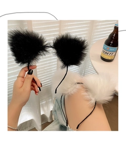 Detail of plush cat ear headbands in black and white with fluffy faux fur texture