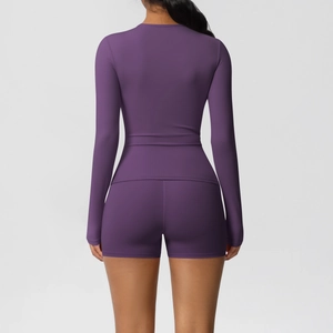 Back view of dark purple brushed yoga set showing high-waisted shorts and slim-fit long sleeve