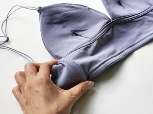 Detail showing the inner padding slot of a purple ribbed cotton backless bra