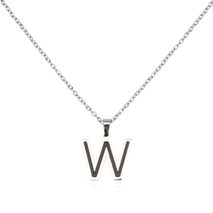 Macro detail of silver stainless steel letter W pendant with black enamel inlay