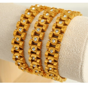 Close-up of three 18k gold plated watch link bracelets with white zircon inlays