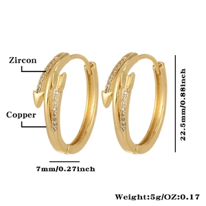 Detail view of 22.5mm gold-plated copper arrow earrings with zircon insets on white background