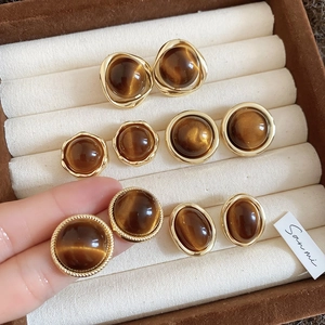 18k gold plated tiger eye geometric stud earrings set in a brown velvet jewelry box