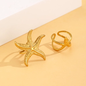 Macro detail of two gold starfish rings with realistic textures and seaside vacation style