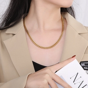 Golden Cuban link chain necklace on model for a stylish hip hop aesthetic