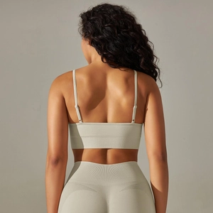 Detailed back view of seamless ribbed knit sports bra with cross-strap design in sage green