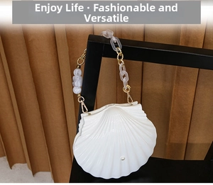 Detailed view of the white shell evening bag featuring an acrylic marble chain link strap
