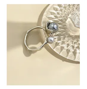 Macro detail of S925 sterling silver ring showing irregular band and dual pearl design