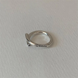 Minimalist 925 sterling silver smile face open ring with engraved lettering on grey background