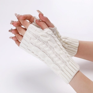 Detailed view of white cable knit arm warmers with fingerless design and soft texture
