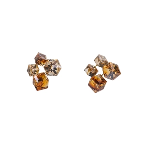 Detailed close-up of geometric square amber crystal earrings with light-refracting facets
