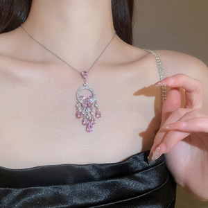 Close-up of pink zircon butterfly tassel necklace on model for an elegant bridal style